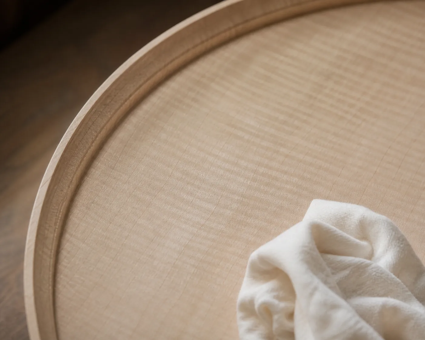 Finished cured pale maple interior surface with a soft matte open-pore sheen and a buffing cloth