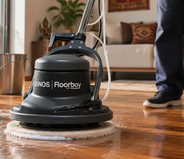 The LEINOS Floorboy working a thin film of soapy water across an oiled teak floor with a white pad