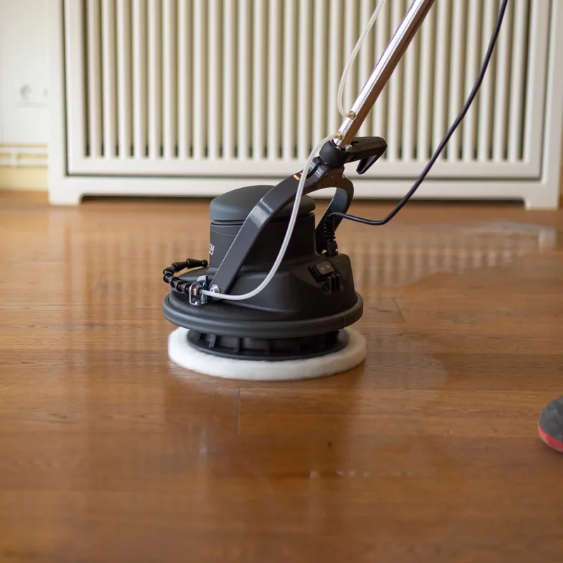 The Floorboy finishing a timber floor with a white polishing pad