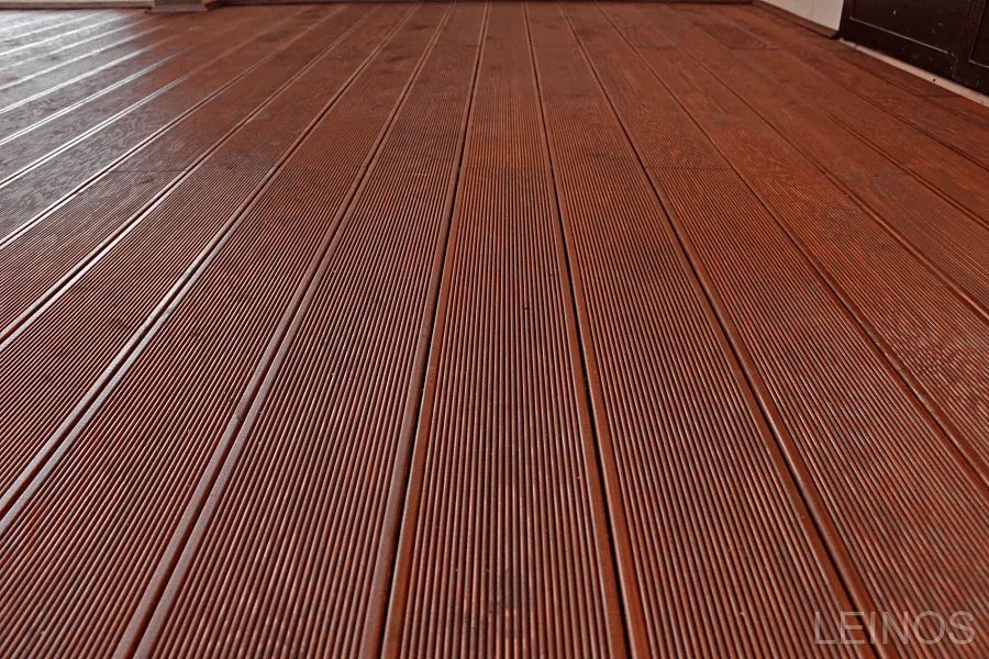 Wide view of the terrace decking surface — uniform dark brown tone across all boards after a single LEINOS Wood Oil 236 application.