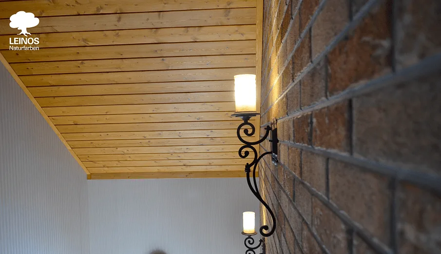 Wide elevation under pendant lighting — warm wood against cool brick perimeter.