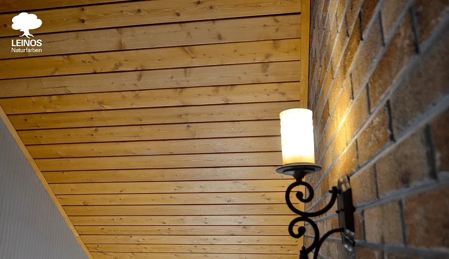 Daylight shot showing the ceiling-to-brick relationship at the wall plate.