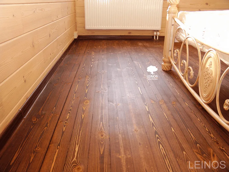 Dark-Stained Larch Floor in Log Cabin Bedroom