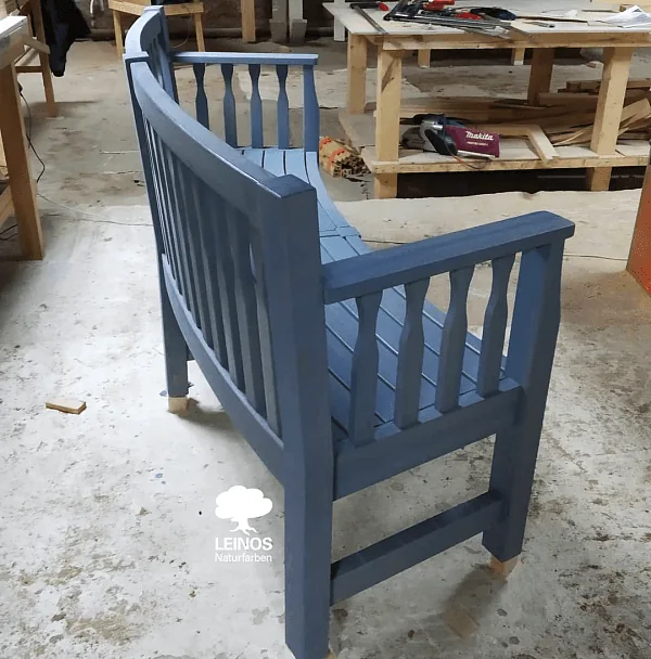 Detail of the curved seat radius and turned spindles — uniform matte coverage across all curves without brush-mark telegraphing.