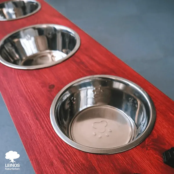Caster-wheel mount underside — pigment + oil holding the colour at the high-contact metal-on-wood interface.