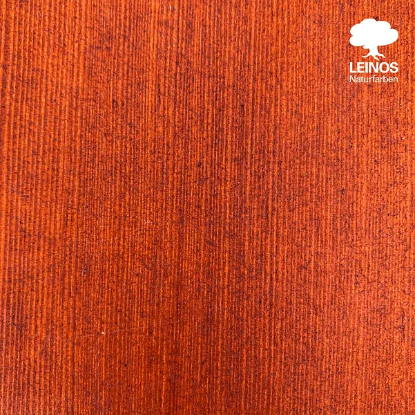 Wide view of the terrace surface — uniform red-brown finish at glancing angle, the oil reading matte with the wood grain still visible.