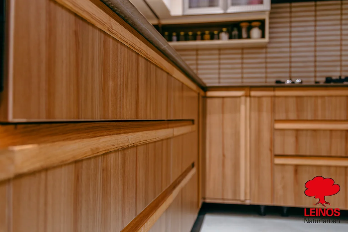 Wall panel knot detail — preserved pine character under the clear oil finish.