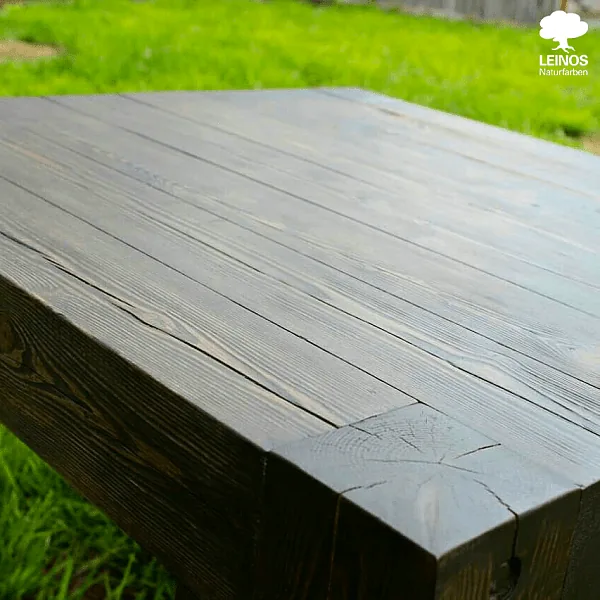 Side elevation of one table — hand-built joinery and apron detail under the dark-stain finish.