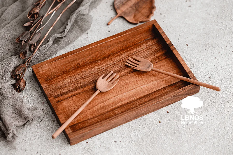 Full collection laid out — uniform warm brown register across bowls, spoons, plates, and coasters.