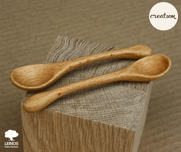 Spoon detail showing fine beech grain preserved under the food-safe oil; bowl-end and handle saturation even with face-grain.
