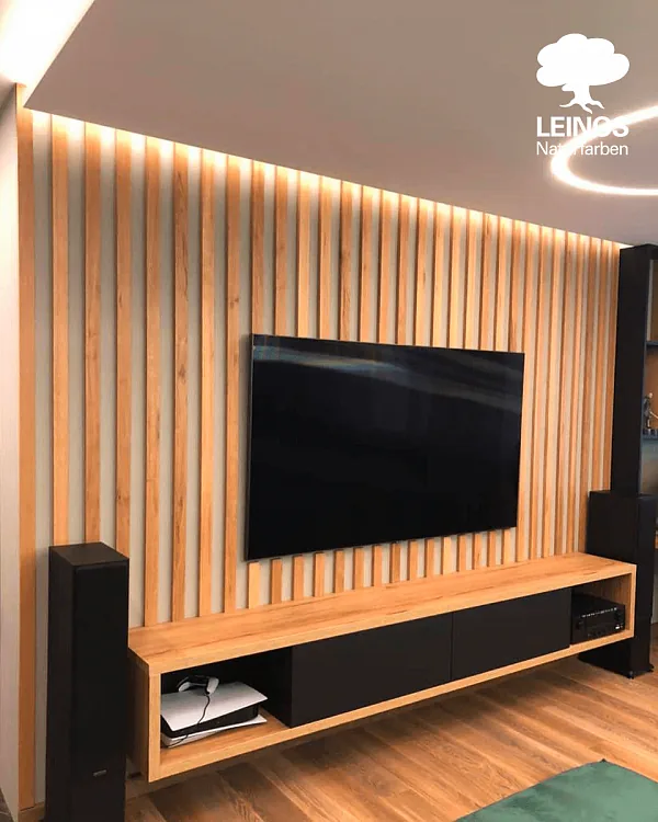 Wide entryway view — slat feature wall set against painted plaster, light catching the slat ridges.